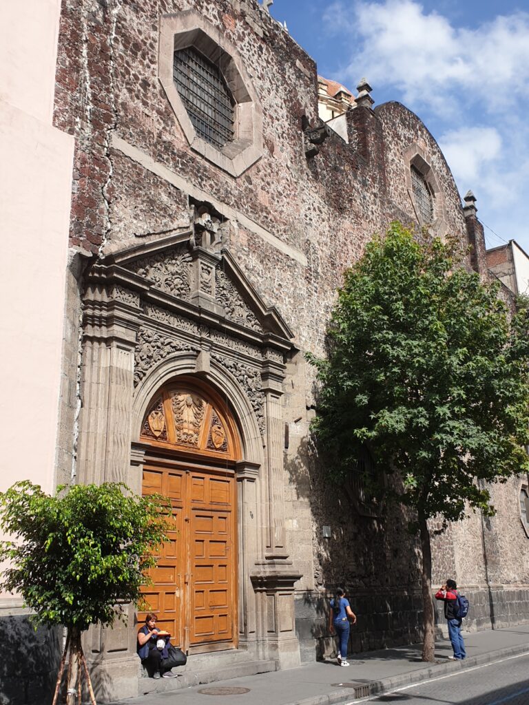 Historic building in Centro Histórico with detailed facade and street activity.