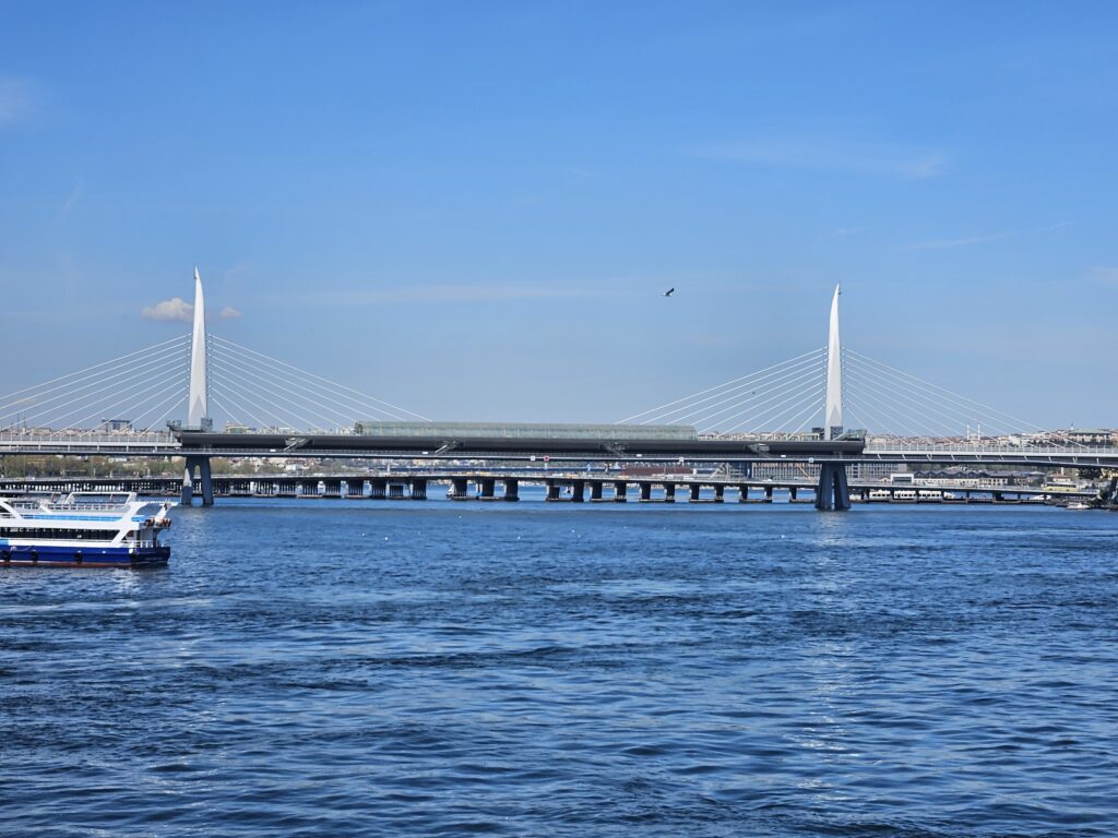 View of a bridge spanning the Bosphorus with water and city skyline in Istanbul.