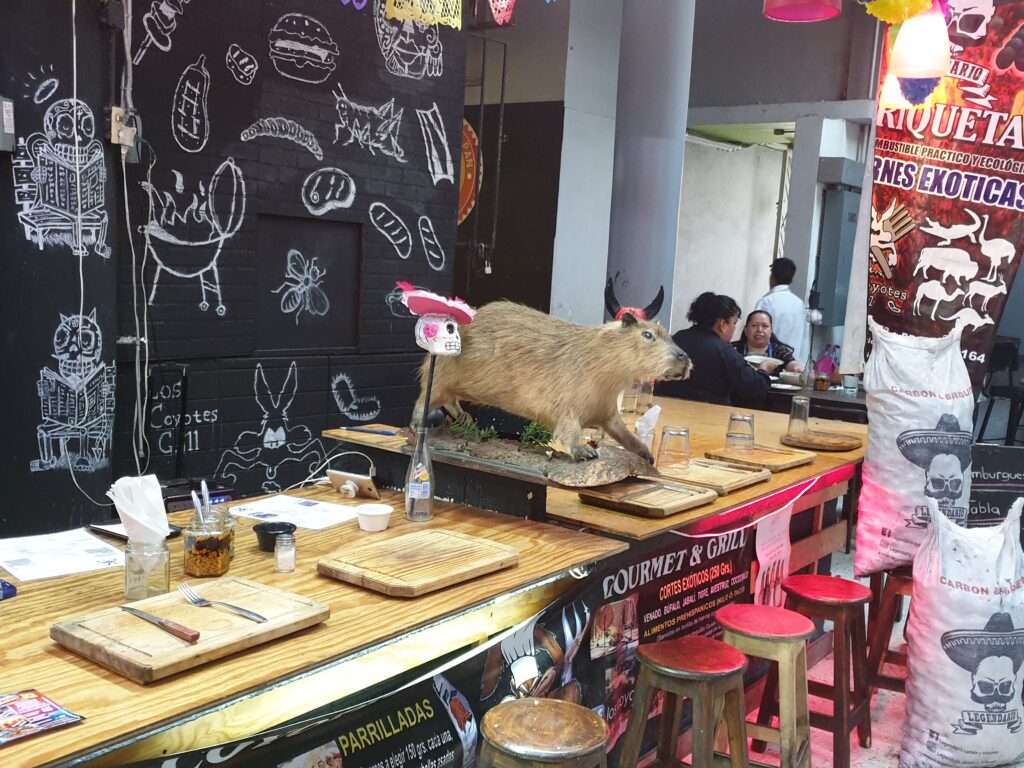 Restaurant stall offering exotic meats inside a Mexico City market.