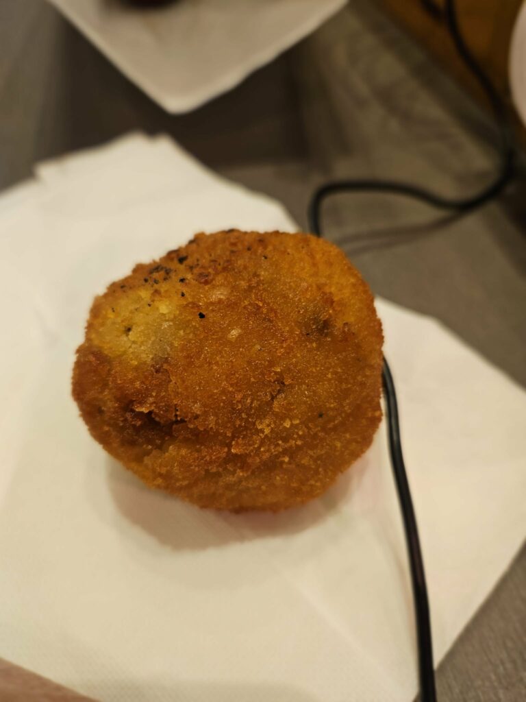 Whole supplì served simply on paper in Rome.
